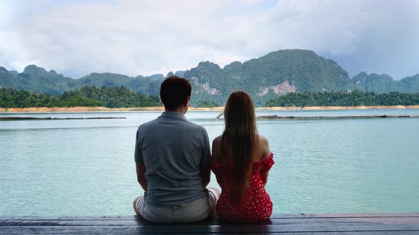 Travel Peoples Sit Together on Date Kissing and Enjoying Lake with Mountains