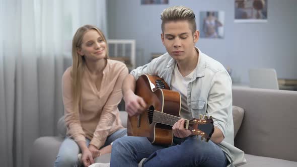 Boy in Love Playing Guitar to Girlfriend Conquering Her Heart, Romantic Date