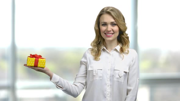 Portrait of Young Sexy Woman Holding Yellow Gift Box with Red Ribbon