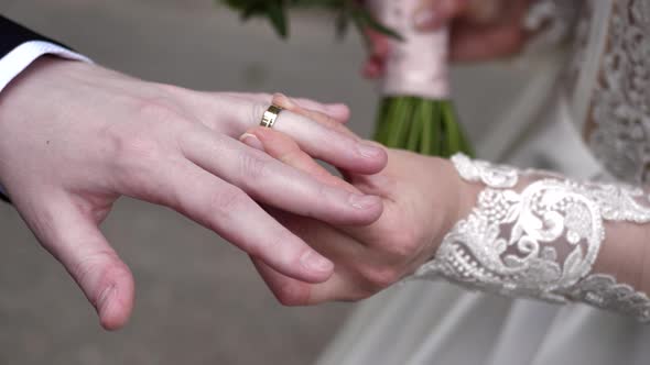 the Bride Puts Her Wedding Ring on the Groom's Finger