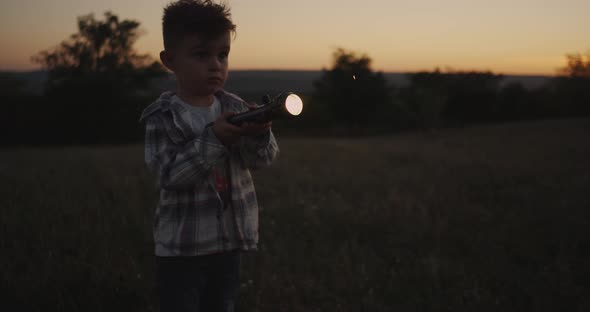 Awesome Looking Boy Playing with a Flashlight