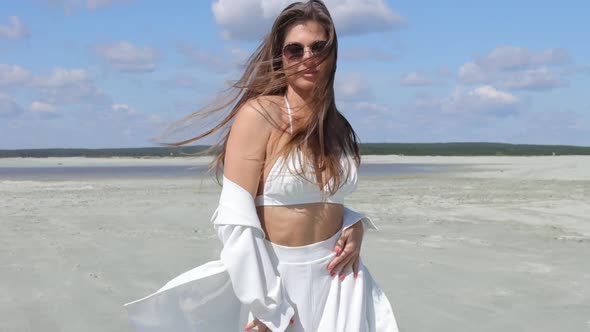 Beautiful Woman Walking on Shore