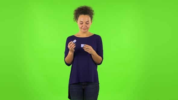 Curly Woman Opening a Small Box with a Surprise and Is Very Disappointed with What She Saw. Green