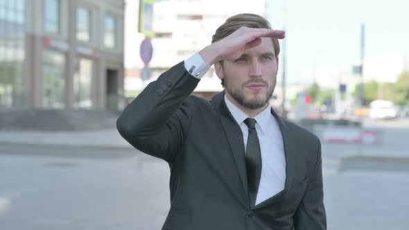 Young Businessman Looking Around for Opportunity Outdoor