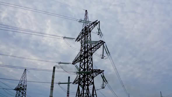 Electrical pylons near the industrial pipes. 