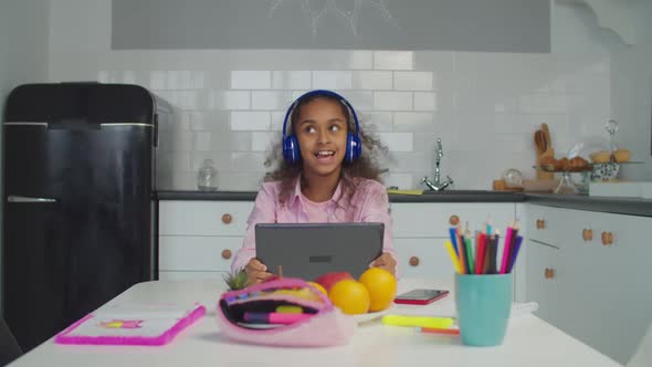 Black Teenage Girl with Tablet Pc Relaxing Indoors