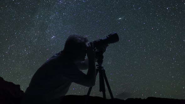 Male Photographer Taking Pictures And Watching Night Starry Sky In Mountains