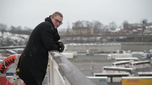 The Person Stands on the Rear Deck of the Ship and Looks at the Winter Landscape