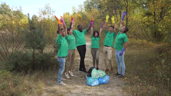 Happy Diverse Activists High Five After Trash Collection