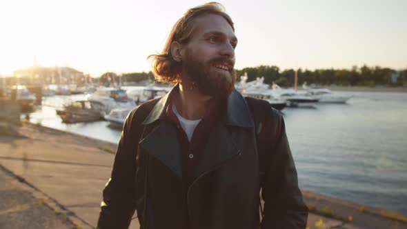 Smiling Man Going along Embankment