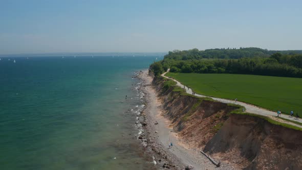 Aerial View of German Coastline Facing Baltic Sea Vast Green Field By Coast with Pathway People
