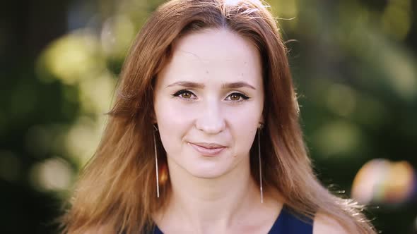 Pretty Girl with Elegant Earrings Smiling at Camera