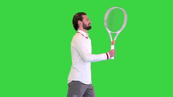 Sporty Tennis Player Walking with a Ball in His Hand on a Green Screen Chroma Key