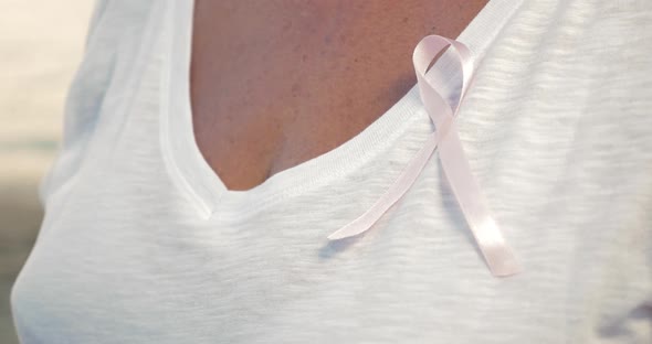 Senior Woman Wearing Pink Awareness Ribbon