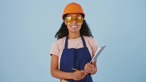 Darkskinned Girl in Hard Hat and Protective Goggles