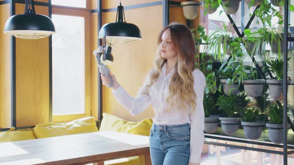 Smiling Woman Holding Selfie Stick with Modern Phone