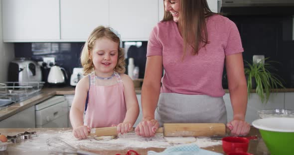 Caucasian mother and daughter having fun cooking together