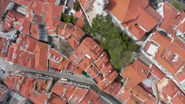 Aerial Overhead Top Down View of Orange Rooftops and Streets Between Small Colorful Houses in Dense