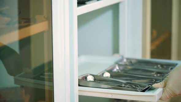 Close Up Shot of a Woman's Hands Who Pulls Out Disinfected Dental Instruments