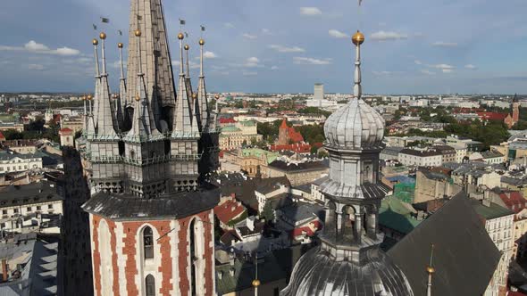 Aerial view of the St. Mary's church spires and the old city in the background during sunny day. Kra