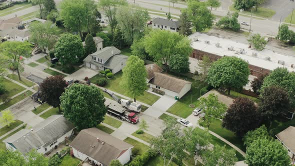 Aerial Drone Futage of Road Repairs in the Suburbs on the Street with Many Houses Laying of New