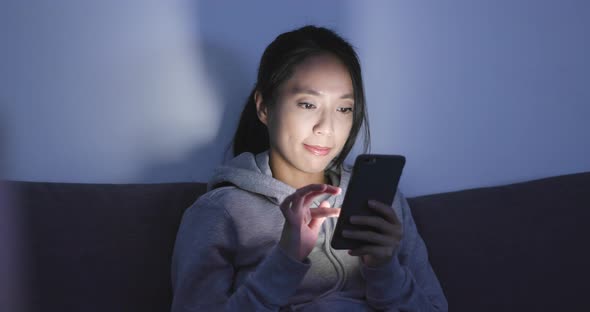 Woman look at smart phone at home