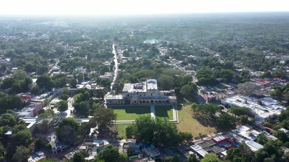 High aerial push in to the Convent de San Bernardino in Valladolid, Yucatan, Mexico in early morning