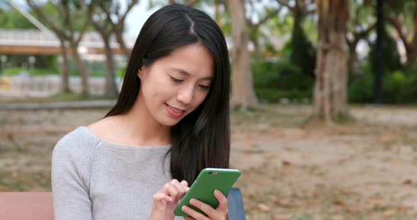 Woman Working on Smart Phone in The Park