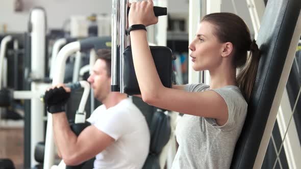 Pretty Woman Doing Exercise on Chest Press