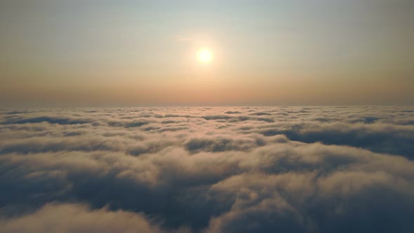 Fabulous Sunrise Over the Clouds. Flight Over the Morning Fog Above the Sky and Sunbeams That