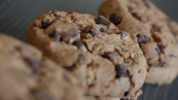 Chip chocolate cookies arranged on wooden table dolly 4K 2160p UltraHD footage - Slow dolly movement