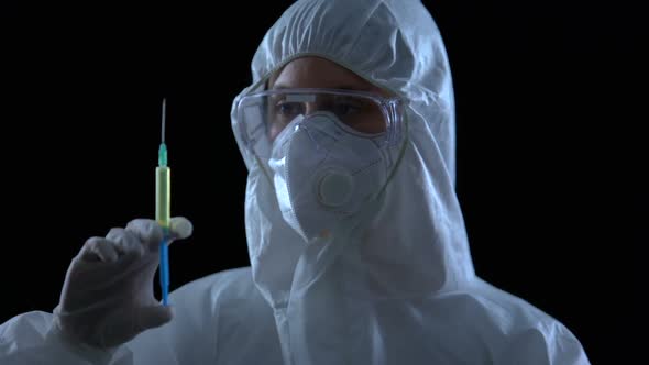 Medical Worker Showing Syringe Against Dark Background, Counterfeit Medications