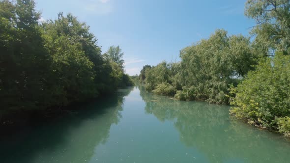 Boat cruising in a canal of the Grado Lagoon in Italy