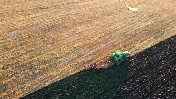 Aerial View of a Tractor Plowing Agricultural Farm Field