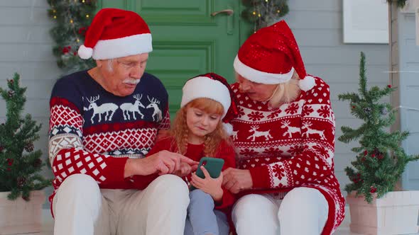 Senior Family Grandparents Granddaughter Purchase Online Christmas Gifts on Mobile Phone Shopping