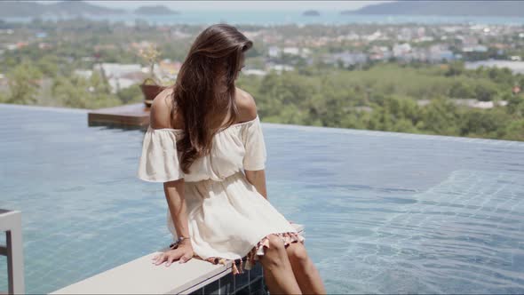 Attractive Woman Having Fun While Resting Beside Swimming Pool in Hotel