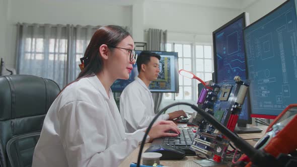Development Facility: Asian Female Engineer Works On Computer With Cad Programming Software
