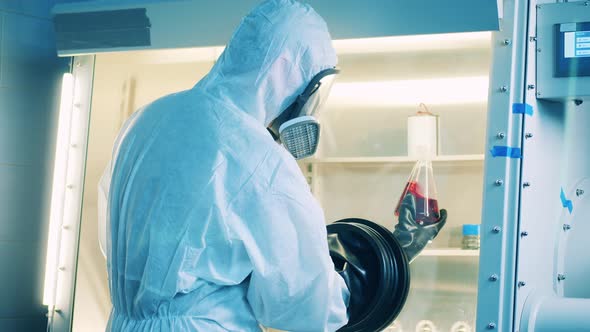 Specialist is Analyzing Liquid in the Vacuum Cabinet