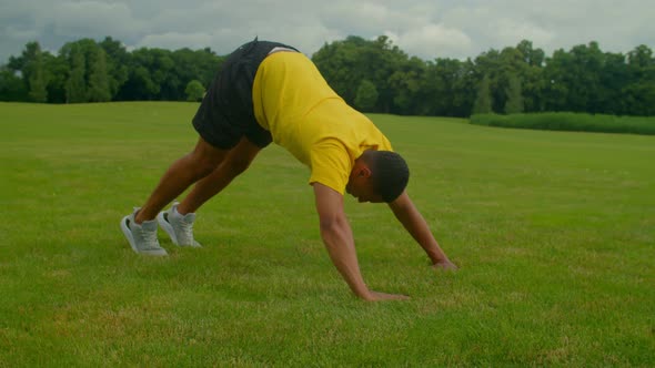 Active Sporty Fitness African American Man Doing Pike Push Ups Outdoors