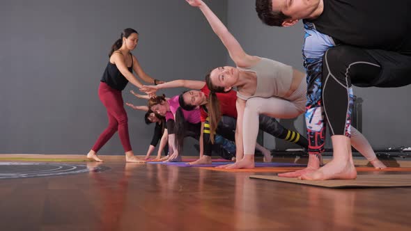 Professional Workout Instructor Shows Exercise to Yoga Group