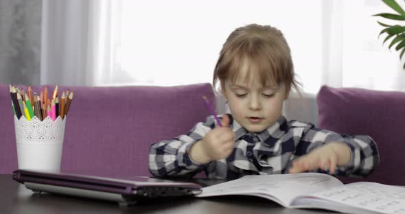 Girl Doing Online Homework Using Digital Laptop Computer. Distance Education