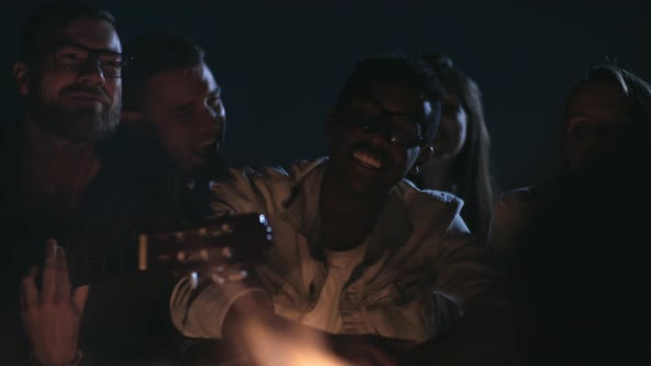 Young People Singing by Campfire