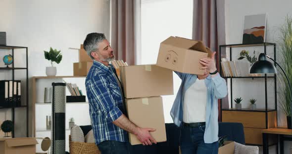 Man Carrying Many Carton Boxes which Pretty Confident Wife Fast Helping to Unload them on the Floor