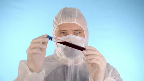 Man in protective uniform injured test tube red substance panicking incident