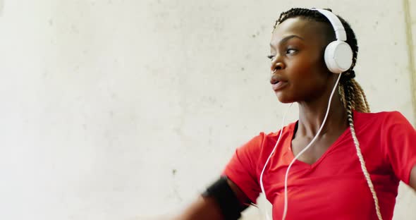 Fit woman exercising with headphones