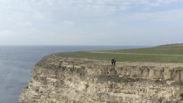 Aerial Shot Active Couple Tourist Standing on Top of High Mountain Together Enjoying Amazing