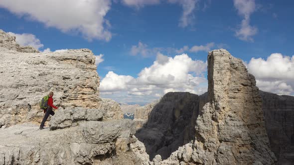 Backpacker Hiking in Montain Landscape. Summer Adventures on Dolomites Alps