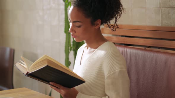 Serious woman reading book