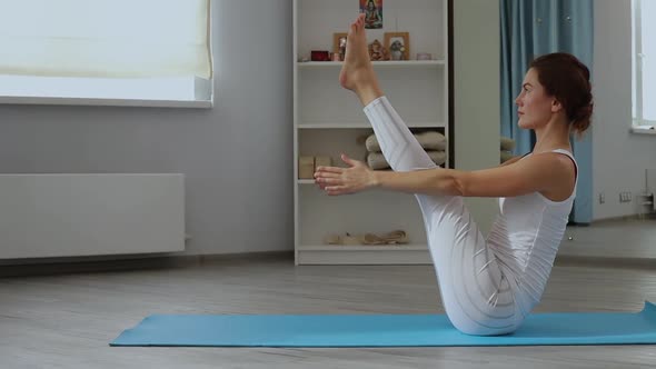 Young Woman Practicing Yoga in Studio