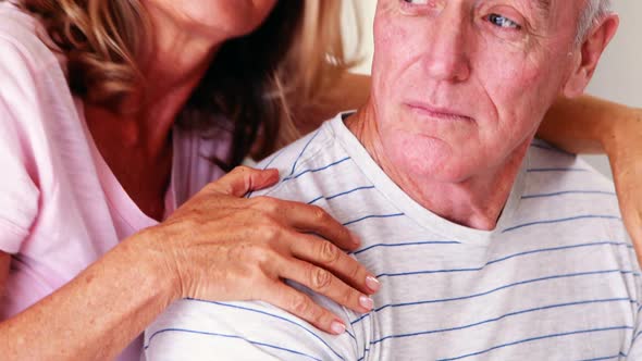 Happy senior couple interacting with each other on bed